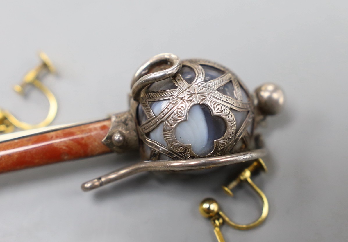A pair of 9ct, amethyst and seed pearl set drop earrings, 20mm, gross weight 1.4 grams and a George V silver and Scottish hardstone mounted sword brooch, 11.8cm.